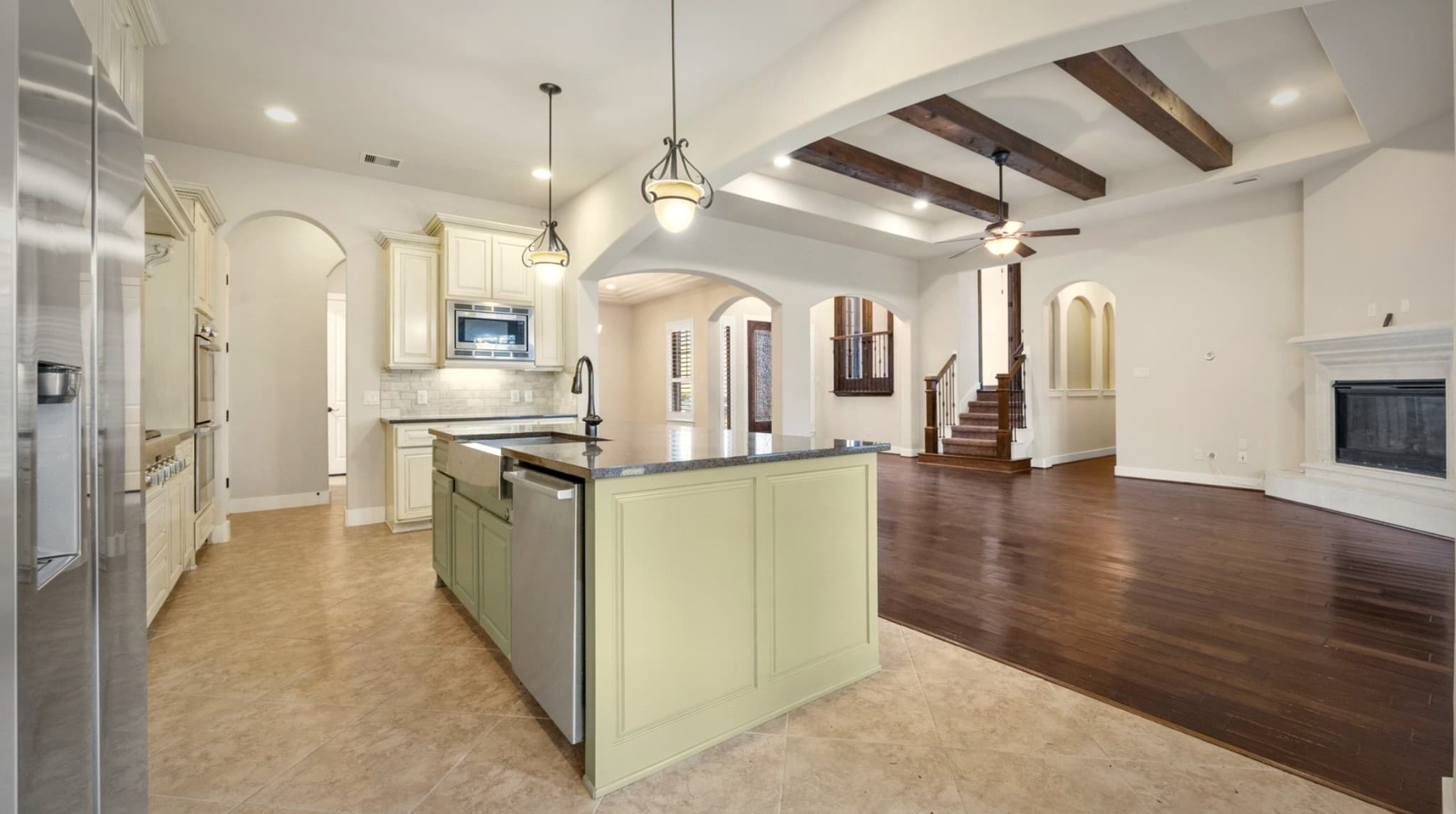 Bear Builders open-concept kitchen and living area with beamed ceiling